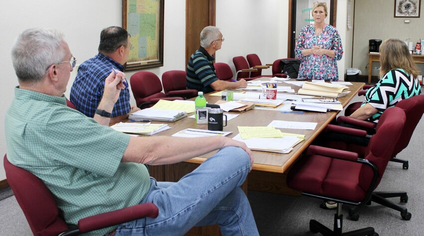 Howell County Commission members recently met for their regular semiweekly session and to hear from County Collector Janet Crow. On Sept. 7, Crow, standing, presented commissioners with the results of sales of properties with delinquent county taxes of at least three consecutive years, held Aug. 28 to recoup those taxes and possibly add some money to the county till in the process. Three parcels were sold with all delinquent taxes and sale costs covered, plus a total of about $45,800 for the county. Southern Commissioner Billy Sexton, left of Crow, praised her handling of the sales and commented she has been doing a fantastic job notifying property owners of delinquent taxes. Other business discussed at the meeting included the submission of architectural plans for lodging improvements at the Christos House Emergency Shelter facility and progress updates regarding the bridge replacement on County Road 2570 about 4 miles northeast of West Plains. Also present for the meeting were Presiding Commissioner Ralph Riggs, foreground, Northern Commissioner Calvin Wood, right of Riggs, and Deputy Clerk Kathy Martin, right of Crow.