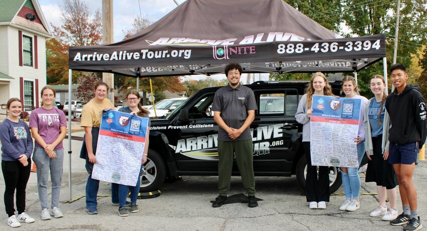 The Bear Ambassadors, a new leadership group at the Willow Springs High School, took a moment to thank Jalen Burris, a representative of health and wellness technology organization UNITE's Arrive Alive Tour. Burris ran an impaired-driving simulation Tuesday and Wednesday at the high school. The students are holding pledges signed by participating students to buckle up and put their phones down while driving to reduce the risks of distracted driving, and the likelihood of being injured or killed or harming others as a result. From left: Bear Ambassadors Katy Spence, Melaina Wilson, Kristen Buster and Nicole Barnett; Burress; and ambassadors Heidi Wehmer, Emma Wiles, Mary Spencer and Will Clarkston.