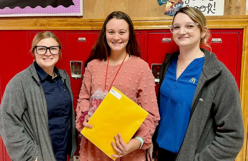 McDonald&rsquo;s of West Plains General Manager Kayla Osburn, left, and McDonald&rsquo;s of West Plains People Experience Lead Ashley Loucks, right, present the McDonald&rsquo;s Outstanding Educator Award Recipient to West Plains Middle School fifth grade teacher Andrea Varney.
