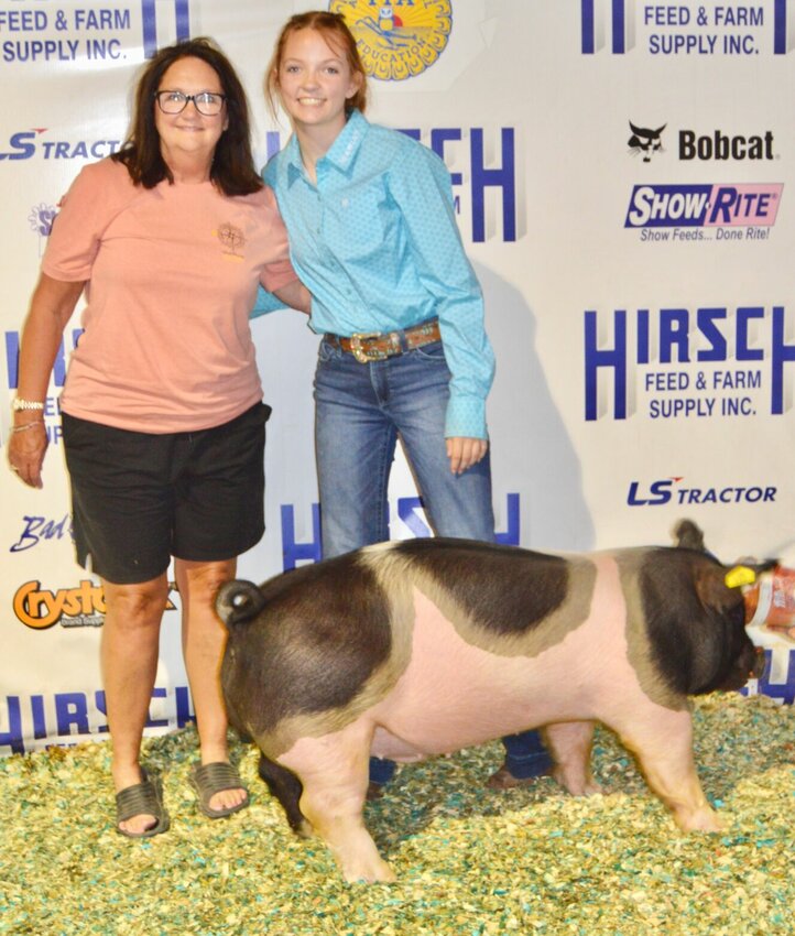 Sydnie Sigert, a Willow Springs FFA member, recently placed among the top five individual competitors in a state-level FFA competition testing youths' knowledge of the swine industry. She is shown here with the 220 pound market hog she sold during the 2023 Heart of the Ozarks Fair to the Garnett Company, represented by Diann Garnett, left. Sigert is the daughter of Josh Sigert.