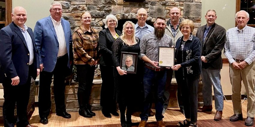 Presenting a certificate to Mandy Harrison, front row, left, and Jacob Bell, front row, center, in honor of over 10 years of service given by their late father, Mark Bell, to the West View Board of Directors is Board Chair Vicki Hogan. Back row, from left: board members Joe Rothgeb, Randy Pace, Becky Wernsing, Dixie Williams, Jack Doss, Jack Spencer, Lyndell Beard and Glenn Miller.