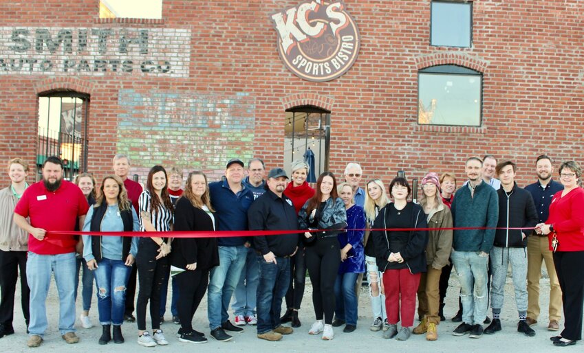 KC's Sports Bistro, 409 Washington Ave., celebrated its first year in business with a ribbon cutting ceremony attended by restaurant staff and members of the Greater West Plains Area Chamber of Commerce. The business is open 10:30 a.m. to 11 p.m. daily, serving wings, burgers, wraps and sandwiches, beer and mixed drinks. A salad bar is offered from 11 a.m. to 3 p.m daily. Call 417-204-4370, or visit the Facebook page, &ldquo;KC&rsquo;s Sports Bistro.&rdquo; Front row, from left: chamber ambassadors Justin Jones and Inam Saba, server Kate Wood, Front of House Manager Tracy Ledgerwood, Nathan Callahan, restaurant owner Keith Collins, General Manager Langley Collins, servers Lizzie Turnbull and Brianna Speake, kitchen staff Alex Farrens, server Deacon Stewart and chamber ambassador Stephanie Beltz-Price.