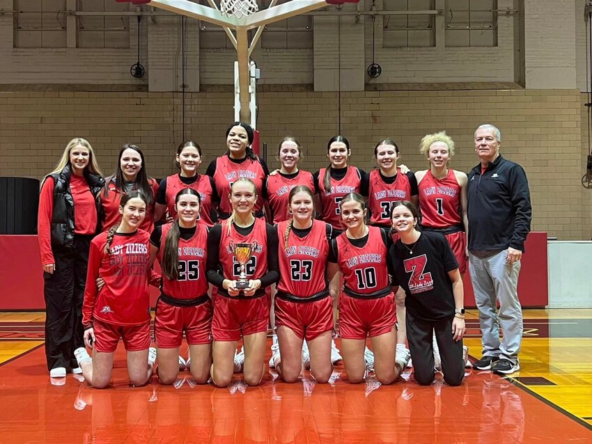The WPHS Lady Zizzers basketball team poses proudly with their 3rd place trophy from the Pink and White Tournament.