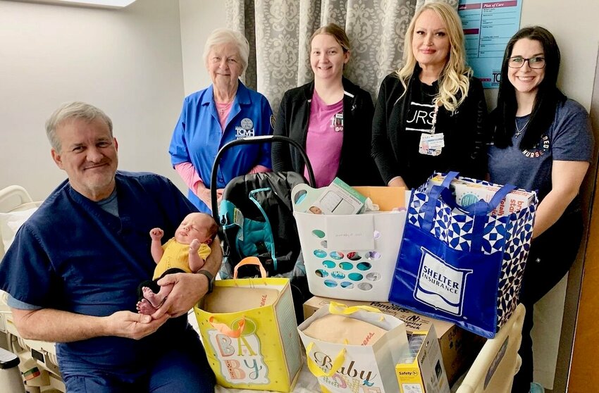 Dr. Christopher Baldwin, sitting, holds Hunter J. Ellis, Texas County Memorial Hospital&rsquo;s first baby of 2024, whom the doctor delivered. With them, from left, are Lana Bucher with TCMH Auxiliary, nurse Jamie Terrill, Obstetrics Director Jennifer Terrill and nurse Heather Day.