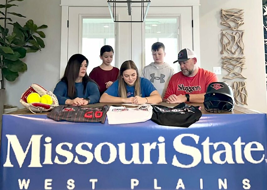MADDIE SAUL, seated center, signs her letter of intent to play for the Missouri State University-West Plains (MSU-WP) Grizzly Softball team beginning in fall 2024. Looking on are her parents, Alison and Steve, seated left and right, respectively, and her siblings, Ava and Alex, standing left and right, respectively.