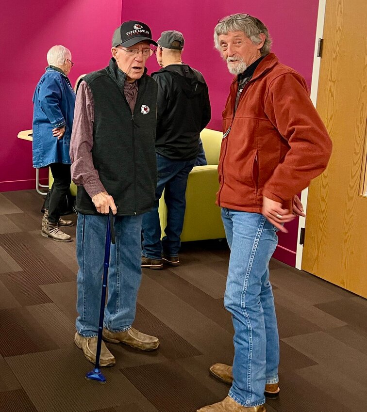 Dennis Crider (right) spent time reminiscing about the the memories contained within the photographs of the exhibit with his longtime friend, and former boss, Jerry Womack, who spent 49 years with the Quill and retired as the General Manager.