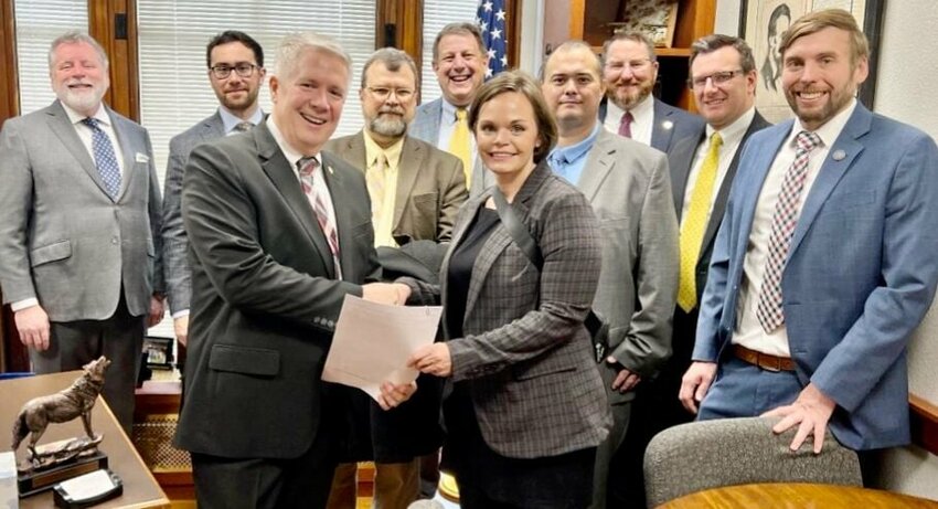 Reviewing a list of this year&rsquo;s legislative priorities proposed by the Missouri Association of Prosecuting Attorneys (MAPA), which named 154th District Rep. David Evans of West Plains its 2023 Legislative Champion, front row, from left: Evans and Annie Gibson, MAPA president and Daviess County prosecuting attorney. Back row: MAPA members Platte County Prosecuting Attorney Eric Zahnd, Cole County Prosecuting Attorney Locke Thompson, Howell County Prosecuting Attorney Michael Hutchings, Johnson County Prosecuting Attorney Rob Russell, Douglas County Prosecuting Attorney Matthew Weatherman, Greene County Prosecuting Attorney Dan Patterson, Cape Girardeau Prosecuting Attorney Mark Welker and Assistant Missouri Attorney General Greg Goodwin.