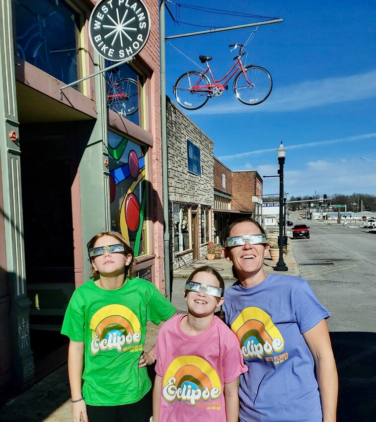 West Plains residents are getting ready for the total solar eclipse on April 8. Here are three members of the Hullinger family testing out their eclipse glasses on a recent sunny day, Washington Avenue, Historic Downtown West Plains. From left: Shiloh, age 11, Abigail, age 9, and mom Stephanie. The glasses, along an assortment of T-shirts and other merchandise, are available at the Ozark Heritage Welcome Center, 2999 Porter Wagoner Blvd.