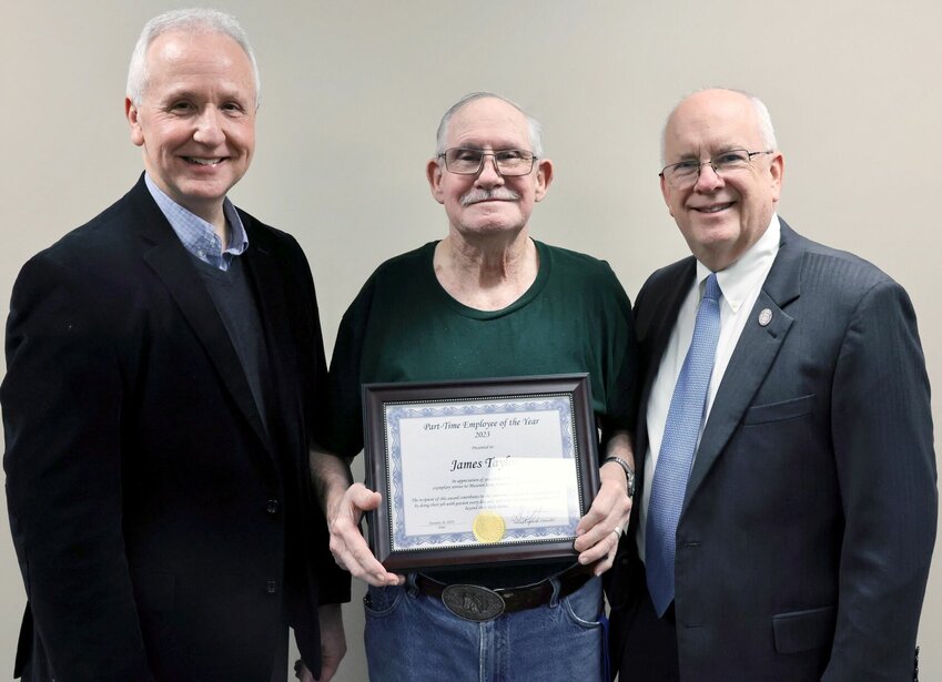 James Taylor, center, has been selected for the 2023 Part-Time Employee of the Year at Missouri State University-West Plains. Taylor, part-time custodian, was recognized as &ldquo;a very motivated, hardworking individual&rdquo; who takes pride in his work and is dedicated to maintaining the buildings he&rsquo;s assigned to. The award, given at the Jan. 26 Employee Recognition Luncheon, recognizes part-time employees who strive to do their jobs well daily, those who go above and beyond the call of duty in a special situation, and those who have contributed in a significant way to the success of the university. Presenting the award to Taylor above are MSU-WP Chancellor Dennis Lancaster, left, and MSU System President Clif Smart.