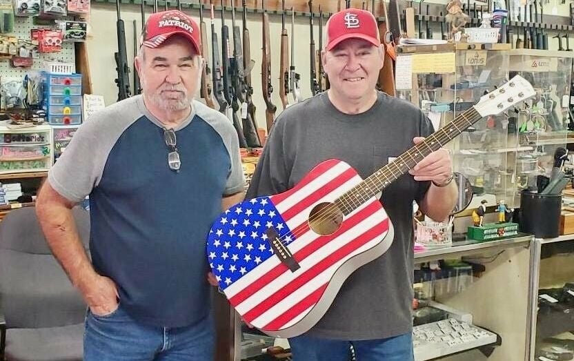 Each year Randy Reese, left, owner of Ozark Trading Post in Mtn. View, donates a guitar signed by the featured performer to Cystic Fibrosis of West Plains' annual fundraising efforts, to be given away at the group's annual concert. This year it is headlined by Missouri native, chart-topper and Grand Ole Opry member Sara Evans. &quot;Each year Randy is so very generous and donates a guitar for our artist to sign for our auction. Some lucky person will purchase a wonderful piece of memorabilia, said Cystic Fibrosis volunteer Rick Frazier. &ldquo;It is not that often that someone from our area gets the opportunity to own something like this, and we appreciate Randy Reese for making this possible.&rdquo; Doors will open for the fundraiser at 5 p.m. March 16 at the West Plains Civic Center. Chances for the guitar will be sold beginning at 6 p.m. Advance ticket prices are $30 for adults and $40 at the door, and $5 for children 12 and younger. Tickets may be purchased with a credit card by phone by calling the civic center at 417-256-8123 or online at Ticketmaster.com/Sara Evans. Accepting the guitar on behalf of Cystic Fibrosis is volunteer Randy Frazier.