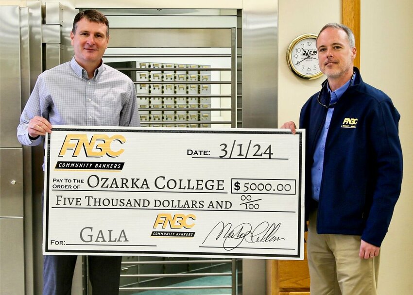 Ryan Howard, Ozarka College board trustee and FNBC regional market president, left, holds a sponsorship check for $5,000 with Matt Rush, Ozarka College Foundation board member and FNBC commercial loan officer.