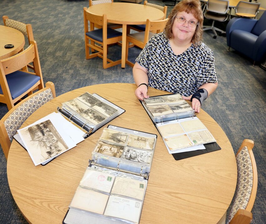 Rebekah McKinney looks through binders containing some of the nearly 1,500 photo cards and postcards donated by local historian and collector Toney Aid to the Ozarks Heritage Research Center (OHRC) at Missouri State University-West Plains. McKinney, director of library services at MSU-WP&rsquo;s Garnett Library and an OHRC board member, said Aid&rsquo;s gift is of great historical value for those researching the Ozarks .