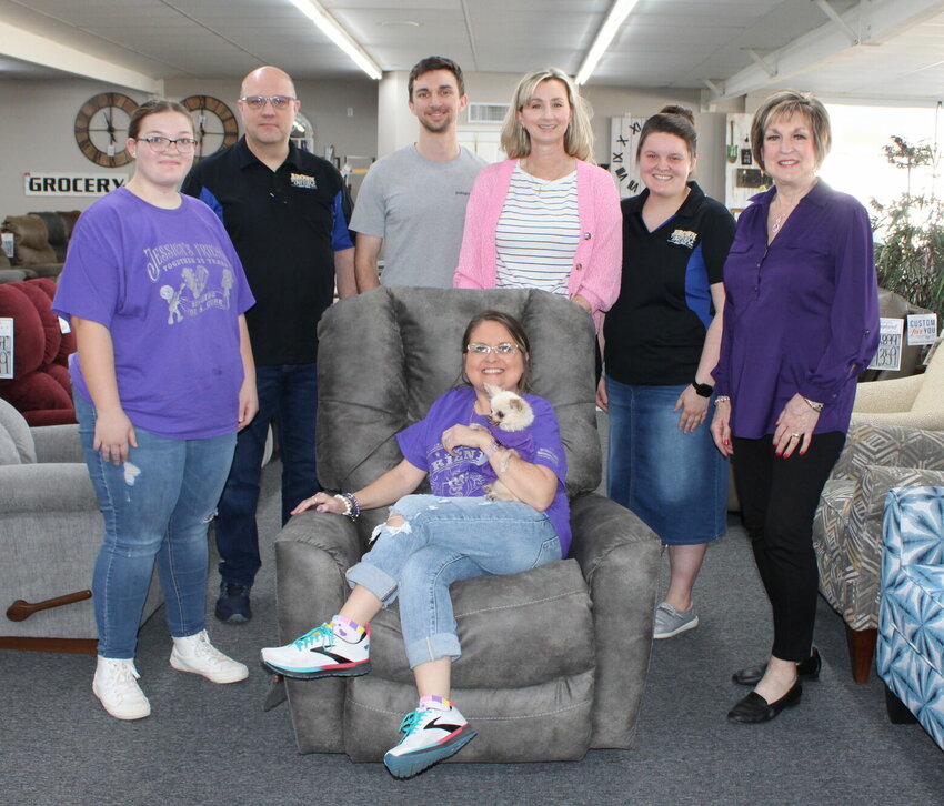 Brown Furniture and Appliance donated a recliner to be auctioned off Saturday at the 36th annual Cystic Fibrosis fundraising concert, which featured country artist and Missouri native Sara Evans. Auction items also included quilts, jewelry, furniture and outdoor gear. This year&rsquo;s benefit raised more than $92,000, said organizers. Seated is Cystic Fibrosis of West Plains volunteer Jessica Joice-Frazier, holding her dog Olive. Standing, from left, are Cystic Fibrosis volunteer Katlyn Johnson; Brown Furniture employees Jason Heath, Zach Brown, Jodi Morrison and Jarissa Wright; and Cystic Fibrosis volunteer Lois Frazier.