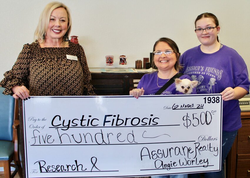 The 36th annual Cystic Fibrosis Benefit Concert was a record breaker this year, thanks to the help of donors like Angie Worley of Assurance Realty, who contributed $500 to the cause of cystic fibrosis research. The event raised $92,601 from ticket sales, donations of auction and giveaway items, and restaurant fundraiser days. From left: Worley and Cystic Fibrosis of West Plains volunteers Jessica Joice-Fraizer holding her dog Olive, and Katlyn Johnson.