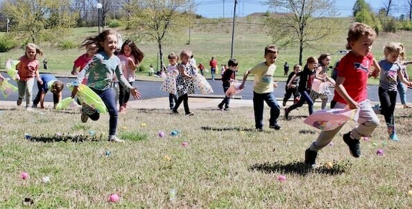 Running to collect Easter eggs filled with candy and small toys, members of Keena Simpson's kindergarten class made the most of their last day of school before a four-day Easter weekend. The students were part of a group that included seven kindergarten classes from West Plains Elementary School, and about 3,000 eggs donated by West Vue Nursing Home and parents of the kindergartners were spread over the lawn of the facility. Some of the eggs were marked with numbers corresponding to larger prizes of filled baskets and toys. The Easter egg hunt, held this year for the first time since the COVID-19 pandemic, is intended to encourage interaction between the children and West Vue residents, who watched the fun from the sidelines.