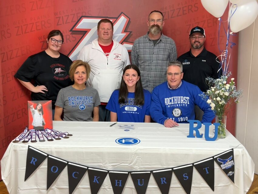 Paige Sheridan was joined by her parents, Kristi (left) and Thom (right) as she signed her letter of intent with Rockhurst University.