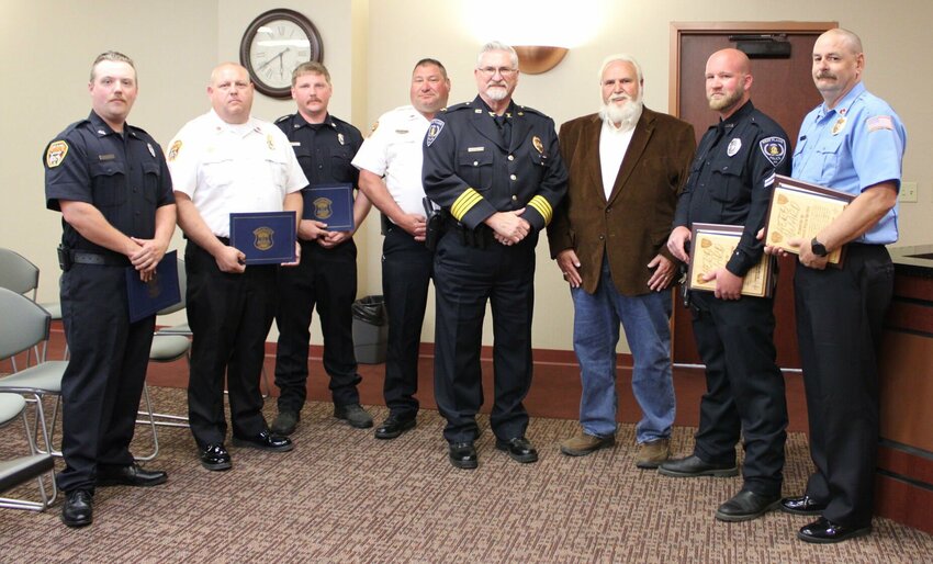 At the April meeting of the West Plains City Council several members of the West Plains Fire Department and the West Plains police Department were recognized for their lifesaving actions, resulting in the handicapped victim of a house fire being removed to safety during a blaze with heavy fire and smoke and the resuscitation of a man that was suffering a severe cardiac event with a low survival rate. From left are Firefighter Jacob Barks, Assistant Fire Chief Chris Sterner, firefighter Brett Wilcox, Fire Chief Kurt Wilbanks, Police Chief Stephen Monticelli, Mayor Mike Topliff, firefighter Jacob Barks, and Fire Lt. Wayne Cormier. Also recognized was firefighter Bud McMillen, who arrived at the medical emergency and helped administer CPR during resuscitation efforts that helped ensure the survival of the patient.