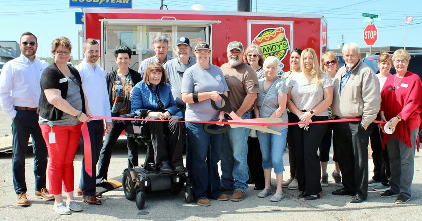 Mandy's Hot Dogs is now a member of the Greater West Plains Area Chamber of Commerce, and recently celebrated with a ribbon-cutting at its new food truck. Menu offerings are regular and footlong Nathan's all-beef hot dogs, Johnsonville bratwursts and nachos. All main dish items may be finished off with a wide variety of traditional and out-of-the-ordinary toppings including pico de gallo, guacamole, pickled red onion, pickled cactus, sauerkraut, cheeses and chili. New twists on the all-American cuisine include the Tangy Mango Pico Dog with mango sauce, and the Pink Panther Dog, topped with chipotle mayo and pickled red onion. Watch &ldquo;Mandy&rsquo;s Hot Dogs&rdquo; on Facebook for weekly locations and menu updates. Sides are bottled sodas and water, and kettle chips. The food truck typically serves lunch from 11 a.m. to 2 p.m. Tuesdays through Fridays in West Plains, and is also available for special events and festivals, plus catering. Call 417-372-1513 to learn more. Front row, from left: chamber members Stephanie Beltz-Price and Jon Hanshaw; Debra and Dave Mayers, their daughter Amanda Roberts, business co-owner, holding scissors, and her husband, business co-owner Gerald Roberts; Judy Tuma; Amanda&rsquo;s sister Kelly Mayers and brother-in-law Jerry Roberts; and chamber ambassador Shirley Butler.