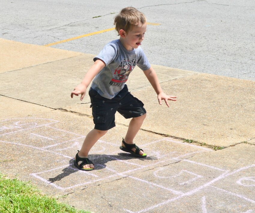 Young Jack Sanders, now 13, plays hopscotch in the Children's Activity Area during the 2015 Old-Time Music, Ozarks Heritage Festival. He is the son of Cody Sanders and Julie Rackley.