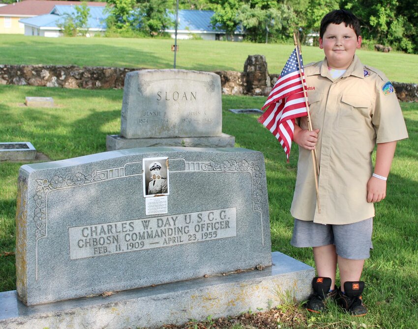 Riley Wheeler, age 10, of Pomona, was one of several scouts, veterans, veteran's service organization members and other volunteers who placed flags on the graves of veterans Friday evening at Oak Lawn Cemetery in West Plains ahead of Memorial Day. The 144 flags were donated by Ace Hardware, and the placement was preceded by comments from West Plains Mayor Mike Topliff, who is a veteran of the U.S. Navy and a longtime Scouts of America leader. Topliff talked about the servicemen and women who are buried at Oak Lawn, some of them going back to the Civil War era, and encouraged participants to think about the history of West Plains and the contributions of those citizens as they honored their memory. Wheeler is a member of Cub Scout Troop 248 of West Plains and the son of Aaron Black and Shaina Wheeler.