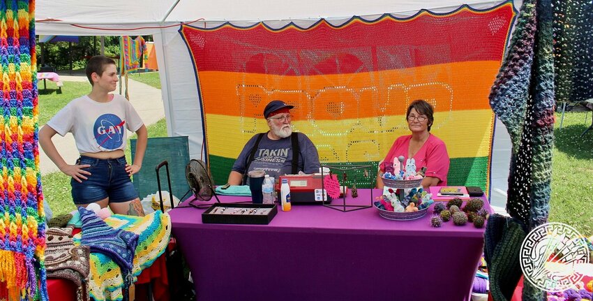 Ambergurumi was one of about two dozen vendors on hand for the two-day West Plains Pride event held in Galloway Park, offering for sale crocheted stuffed animals crafted by artist Amber Bourland, right. Seated to the left of Bourland is her husband, Randall. Joining them, standing, is their child Eli Isaiah.