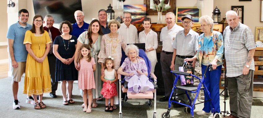 Kathryn Bratton, who turned 100 on June 17, celebrated her longevity Saturday afternoon at her home, West Vue Whispering Pines, surrounded by family, friends and representatives of county and state government. Officials presented her with proclamations and resolutions recognizing her contributions to the community, and Howell-Oregon Electric Cooperative Member Services Manager Myles Smith was on hand with the gift of a blanket. Smith noted Bratton was perhaps the electric cooperative's oldest and longest-standing member, and still has an active account in her name. Front row, from left: Bratton's grandson Michael Harrington and wife Kristin; Howell County Clerk Kelly Waggoner; granddaughter Stephanie Harrington with Michael and Kristin's daughters, Eleanor and Amelia; Bratton's daughter Katherine Harrington; and Bratton. Back row: son-in-law Terry Harrington, nephew John Perkins, Smith, Bratton&rsquo;s son Bill Perkins and wife Susan, 154th District State Rep. David Evans and Bratton&rsquo;s cousins Duard Ehrhart, Colleen Harbison and Harold Harbison.