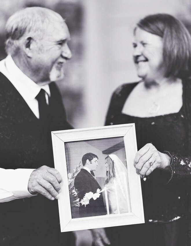 John and Judy Stewart at Mt. Zion, Akers. The couple, holding a framed photo of their 1974 wedding day, recently celebrated 50 years of marriage.