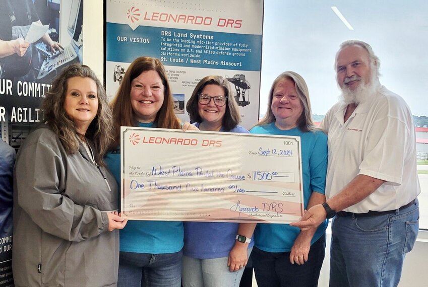 From left: Jana Barton of Leonardo DRS and Pedal the Cause volunteers Michelle Cobban, Heather Legler, Pam Topliff and Mike Topliff, who is also with Leonardo DRS.