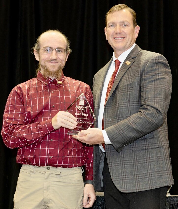 Biff Bird, left, systems database analyst at Missouri State University-West Plains received the Staff Excellence in University Service award from MSU during the annual Staff Service Awards Luncheon Jan. 8 at the Springfield campus. The award, given annually, recognizes employees who strive to do their jobs well on a daily basis, who go above and beyond the call of duty in a special situation, and who have contributed in a significant way to the success of the university. Recipients receive a $1,500 cash award from the university and a plaque. Bird receives his award above from MSU System President Biff Williams.
