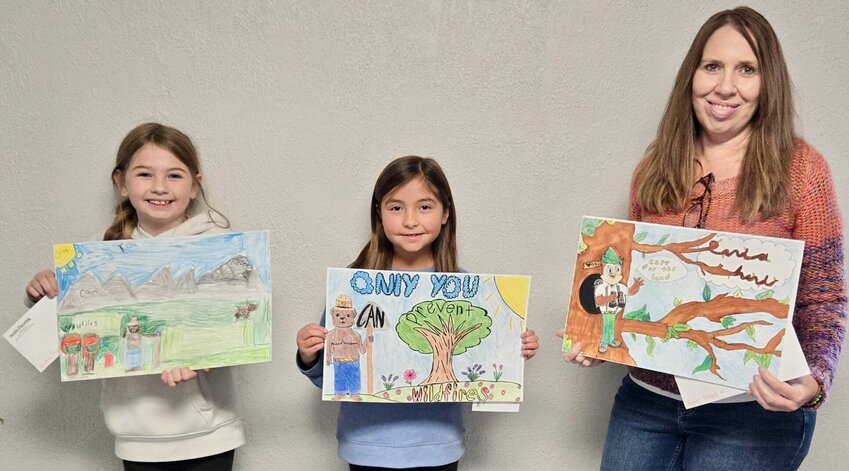 Winners in the Smokey Bear and Woodsy Owl poster contest sponsored by the Mtn. View Garden Club and Smith Flooring included these Birch Tree Elementary students. From left are Gianna Gramlisth, in the fourth grade and a fourth place winner; fifth grader Cataline Garza, first place; and art teacher Mara Pace, standing in for fifth-grader Brilee Dillard, who won second place. The entries of first place winners will go on to the State Garden Club contest.