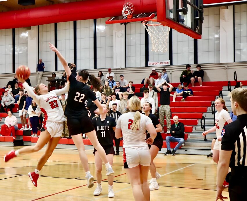 Ashley Culton takes the one-hand shot with a defender all over her.