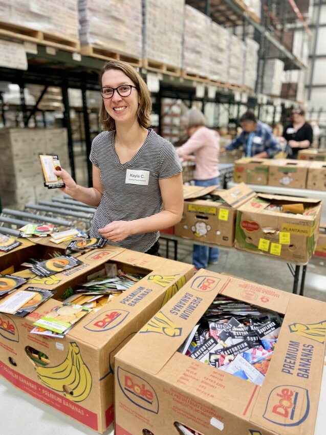 Ozarks Food Harvest volunteer Kayla Cotter is one of many who worked through February to assemble $1.5 million worth of donated seeds into kits to be distributed to households across the region to combat hunger.