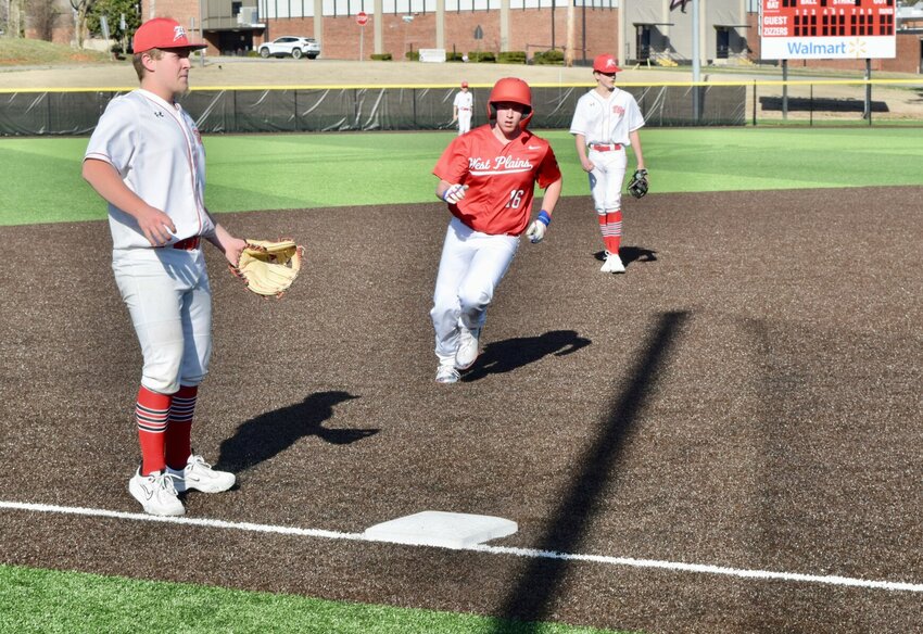 West Plains Zizzers freshman Alec Rogers runs to third base as Camden Bryant, right, and freshman Creyton Sullivan play defense Thursday during the baseball team's Red and White scrimmage at the Zizzer Baseball field. The red team, made up of freshmen and sophomores, defeated the white team, all freshmen, 5-3.