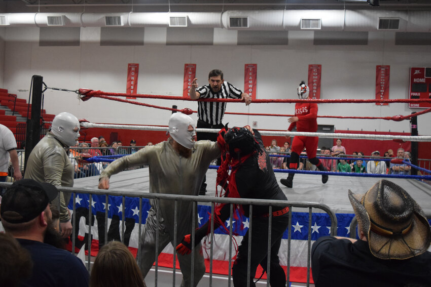 The Masked Havana, left, and Sundown fight outside the ring during a match Friday at the West Plains Middle School FEMA building. The event was a fundraiser for the 37th Judicial Court Appointed Special Advocates, and through about 250 ticket sales, concessions and a silent auction, the event raised $2,187 to go toward advocates' mileage reimbursement. Sundown won the match.