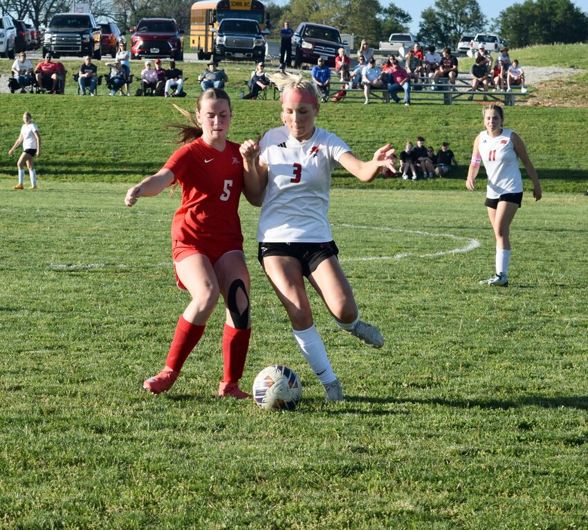 It was a 4-0 win for the Lady Zizzers Soccer team Tuesday, as the girls defeated Branson at the West Plains High School soccer field. "The game against Branson was a good one," Lady Zizzers assistant coach Kourtney Stockton said. "This was our first game on the grass field, and the girls played exceptionally well." The Lady Zizzers were forced to move to the grass field after recent flooding ruined the turf field at Zizzer Stadium. The game was 1-0 at the half, with Lyndzey Casey having scored the goal. The Lady Zizzers scored three times in the second half: one by Addison Talburt, her first of the season; Lilly Hamilton scored a goal; then Casey sent in the last goal. "The girls were looking for each other, making great passes and talking to each other very well," Stockton said. Prior to the varsity game, the junior varsity team tied Branson 0-0. The Lady Zizzers are next scheduled to take on the Marshfield Lady Blue Jays, 5 p.m. Tuesday at Marshfield. Here, Talburt, left, battles Branson's Sarah Cox for control of the ball to score her first goal of the season.