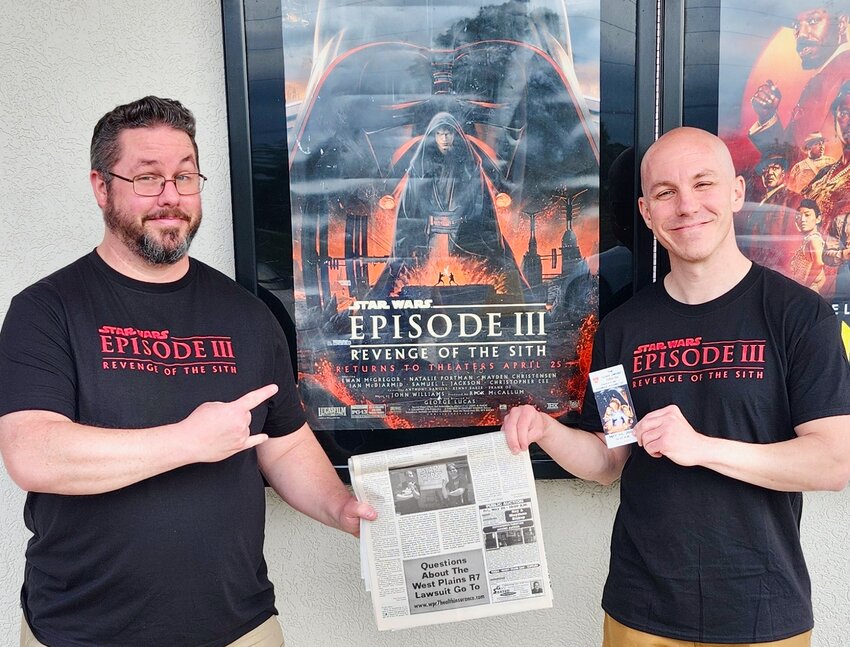Brothers Eddie, left, and Josh Warren, of Springfield and St. Louis, respectively, traveled to their former home of West Plains to watch the re-release of Star Wars Episode III: Revenge of the Sith at the Glass Sword Theatre, where they watched the film the first time it was released 20 years ago. They are holding a copy of the Quill which bears a photo of the brothers camped out in line hours before the box office opened, determined to be the first to buy tickets. The Warren brothers also attended Oz-Con over the weekend, cosplaying as the Ghostbusters, complete with an Ectomobile, in what&rsquo;s become an annual tradition.