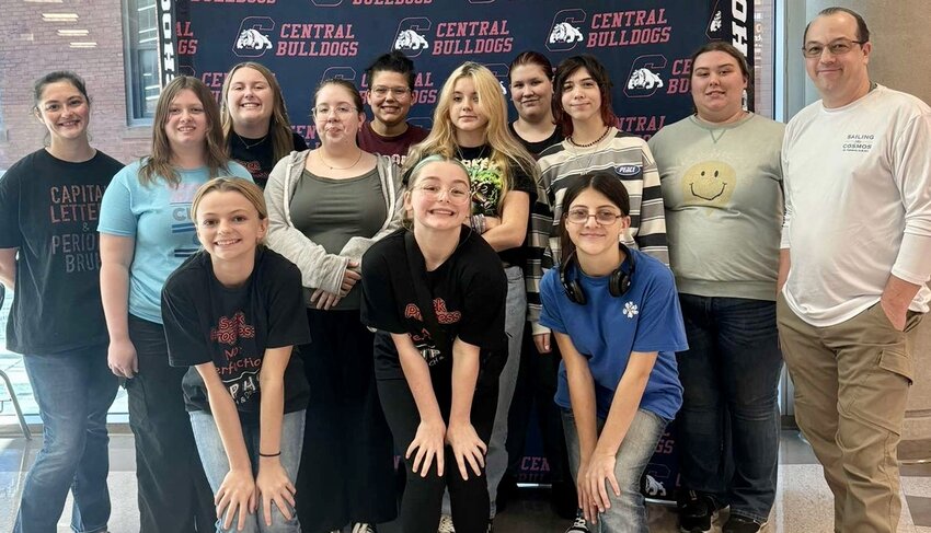 Coaches Brittany Moore, far left, and Lane Schilmoeller, far right, join West Plains High School Speech and Debate student competitors for a photo at an early-year clinic held at Central High School in Springfield.