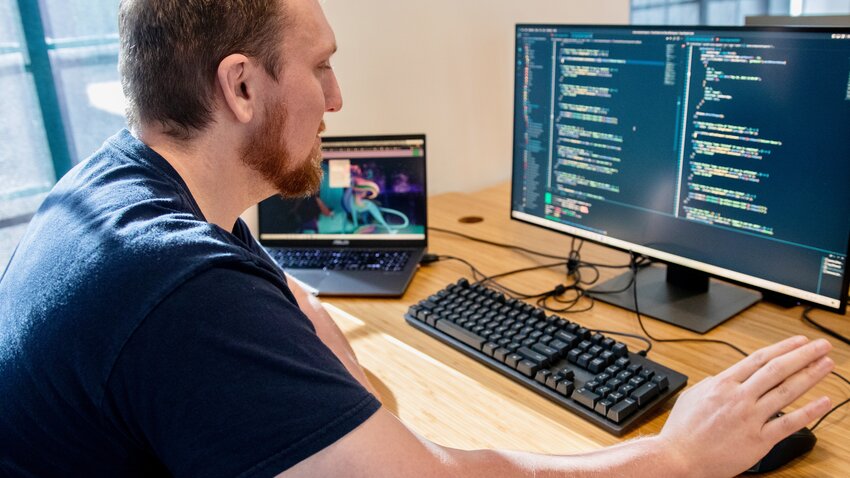Cameron Hutchison, a contractor for codefi, works on a project at his computer.