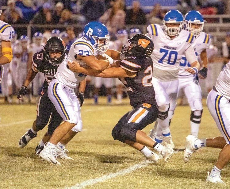 Wayne linebacker Brannon Lewelling (22) goes head to head with a Ringling ball carrier Friday night. The Bulldogs fell to the Blue Devils 36-0. Lewelling had 13 tackles.