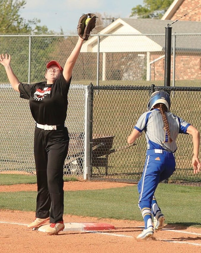 Purcell senior Kaylee Evans reaches for a ball for the out at first base Monday against Holdenville. Purcell was defeated 13-1 by the Wolverines. They travel to Sulphur today (Thursday) for the District tournament against the Bulldogs.