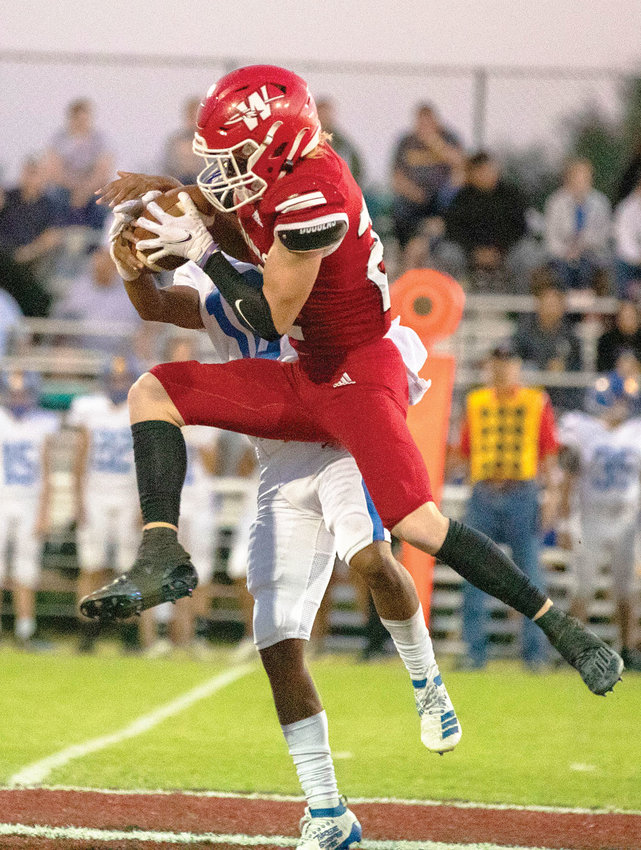 Washington senior Reese Stephens picks off a Holdenville pass during the Warriors&rsquo; 69-0 win over the Wolverines. The interception was one of eight on the night.