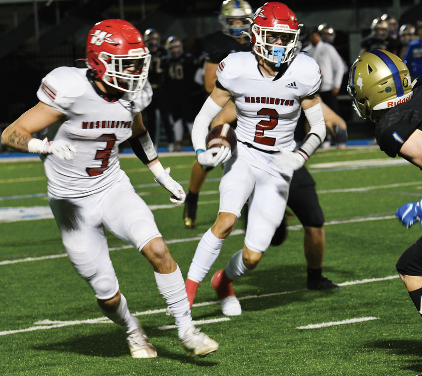 Washington senior Luke Hendrix (2) carries the ball Friday night during the Warriors&rsquo; 54-28 win over Rejoice Christian. Hendrix scored three touchdowns in the game. Washington plays  Beggs this Friday night in the State semifinals at Langston University at 7 p.m.