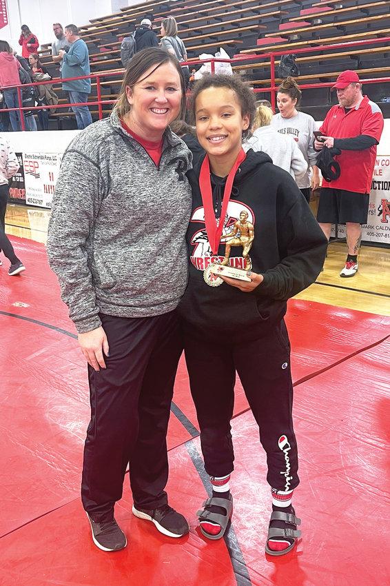 Coty Sessions, who won the 107 pound weight class recently in Pauls Valley&rsquo;s Invitational Wrestling Tournament, was named the Outstanding Wrestler for the lower weights in the tournament. She is pictured with her coach Sarah Jones.