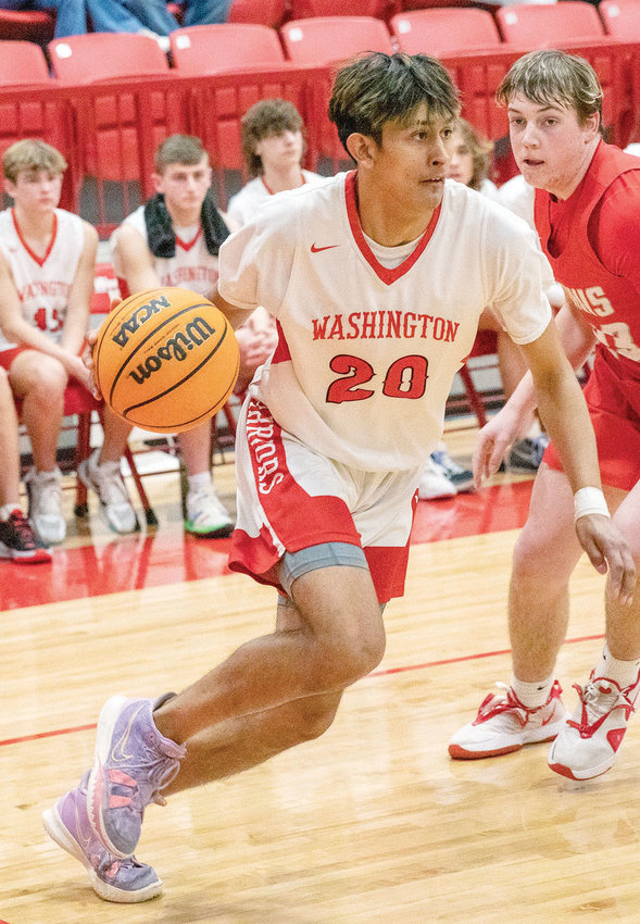 Washington senior Hector Quinonez drives to the bucket against Davis during the Warriors&rsquo; 57-49 win. Washington plays Chisholm on Saturday at 8 p.m. in the District tournament.