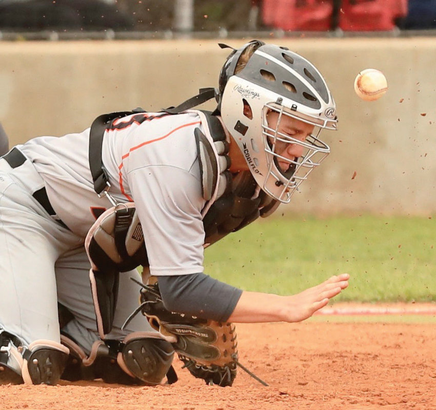 Wayne junior Rhett Kennedy blocks a pitch from his catcher position during the Heart of Oklahoma Baseball Tournament. Wayne travels to Caddo for the District tournament.