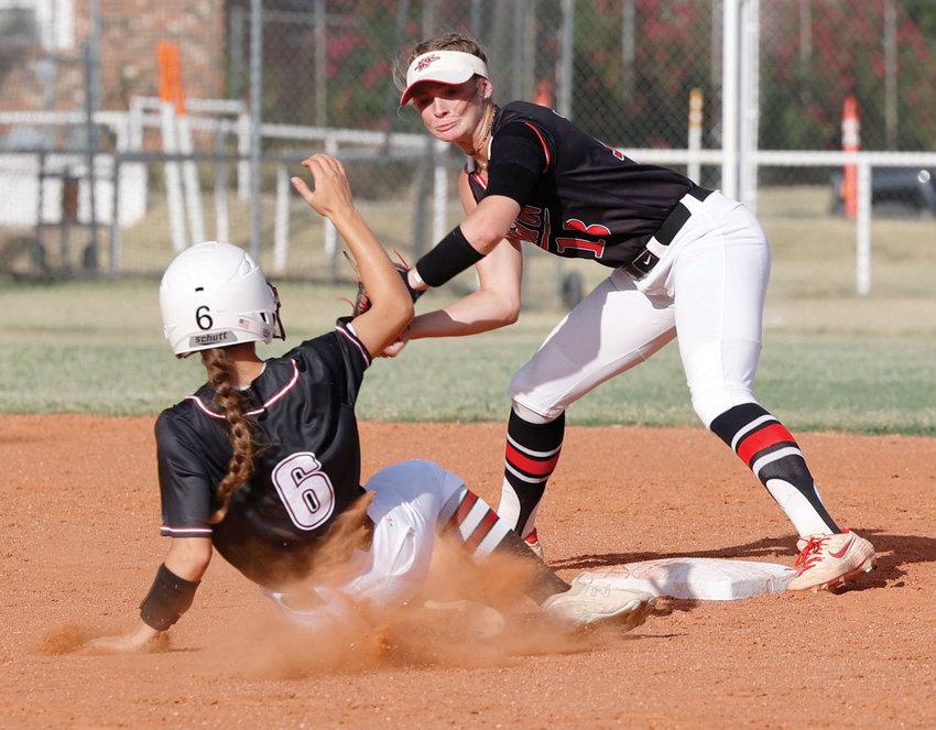 Washington senior Ellie Loveless tags a Tuttle base runner during the Warriors&rsquo; 2-1 win over the Tigers on Monday.