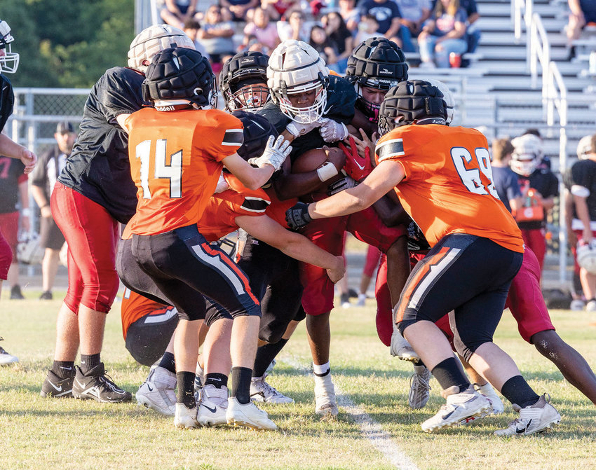 The Lexington defense corrals a Wynnewood ball carrier Friday during the Dawgs&rsquo; three-way scrimmage, which included Minco. Lexington opens the season at home Friday against Bridge Creek at 7:30 p.m.