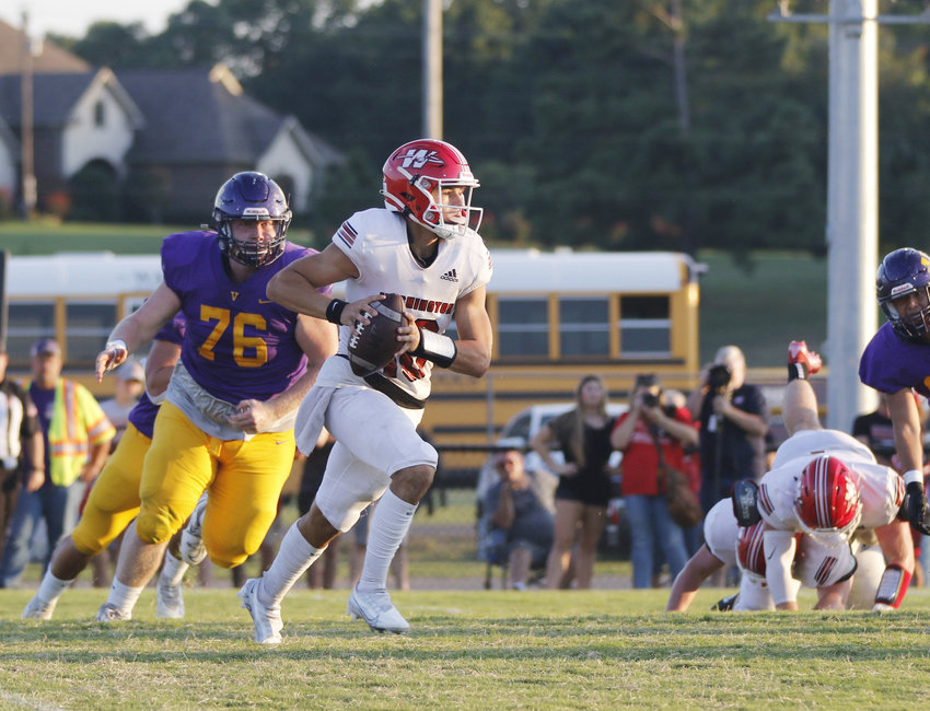 Washington junior Major Cantrell looks for a receiver Friday night during Washington&rsquo;s 39-24 win over Vian. Cantrell finished the night with 151 yards through the air and two touchdowns.