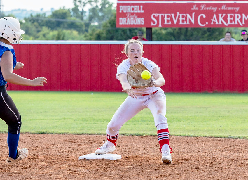 Purcell senior Lauren Holmes watches the ball all the into her glove while covering second base. Holmes and the Dragons play at Chickasha today (Thursday).