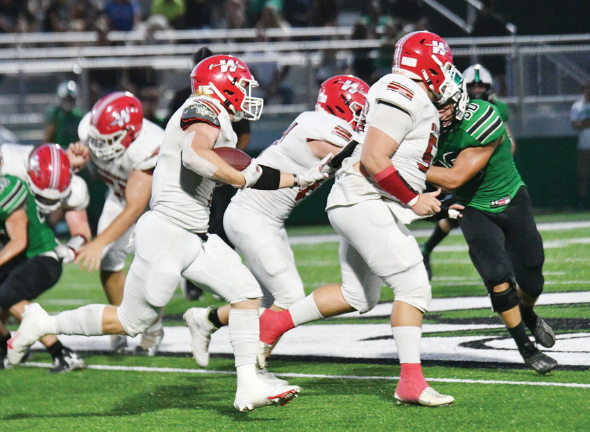 Washington senior Cole Scott (7) gets help from his senior buddy, Caleb Bruce (53), in the form of a lead blocker during the Warriors&rsquo; 33-14 win over Jones.